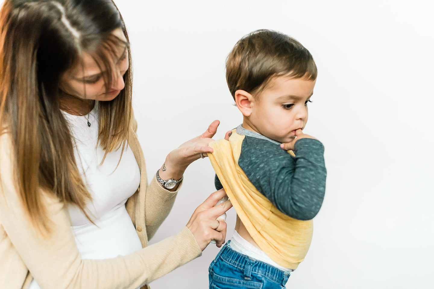 mom applying Raise Them Well kid-safe magnesium oil sleeping serum to her toddler
