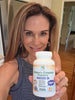 Woman holding a bottle of children's chewable probiotic