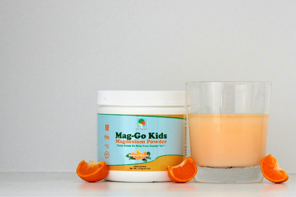 container of Raise Them Well orange-flavored Mag-Go magnesium powder for kids' constipation relief with glass of Mag-Go magnesium drink for kids